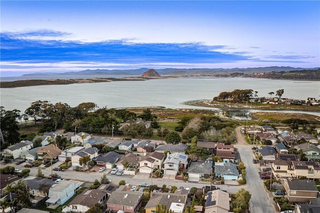 drone / aerial view with a water view and a residential view