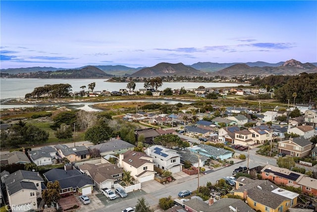 drone / aerial view featuring a residential view and a water and mountain view