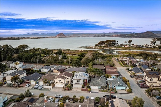 birds eye view of property with a residential view and a water and mountain view