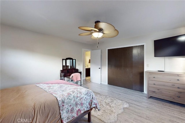 bedroom featuring a ceiling fan, a closet, and wood finished floors