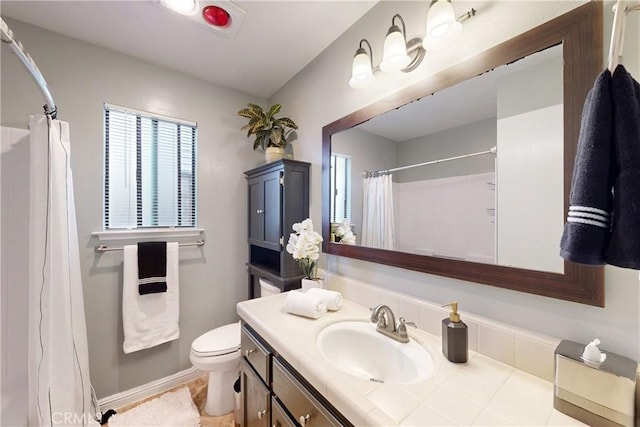 full bath with curtained shower, plenty of natural light, vanity, and toilet