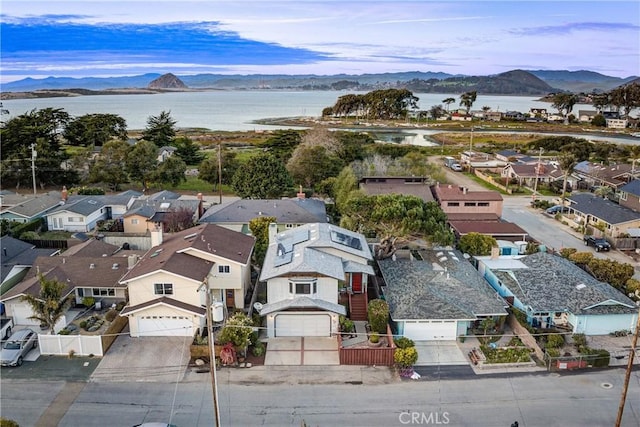 aerial view featuring a water and mountain view and a residential view