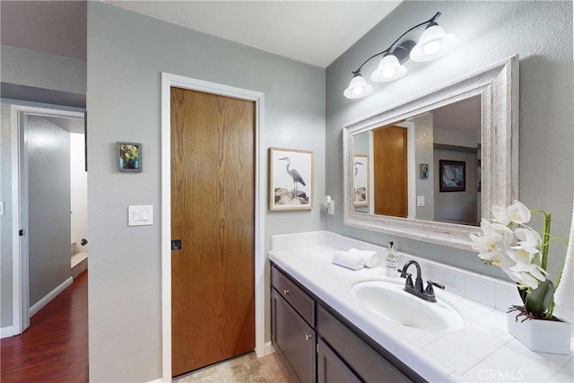 bathroom featuring vanity and baseboards