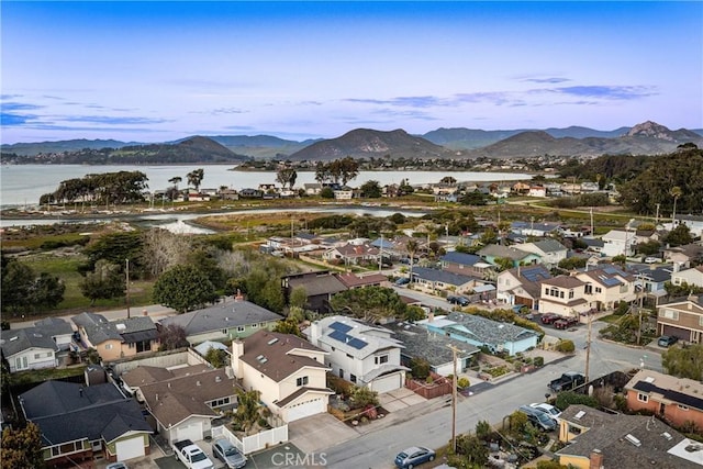 birds eye view of property with a residential view and a water and mountain view