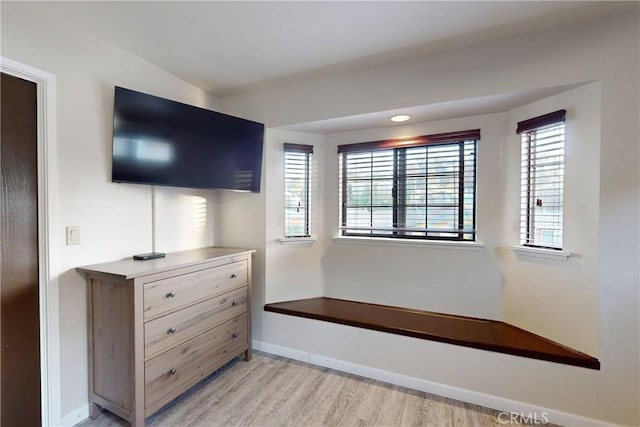 interior space with light wood-style floors, plenty of natural light, and baseboards