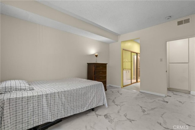 bedroom featuring marble finish floor, visible vents, a textured ceiling, and baseboards