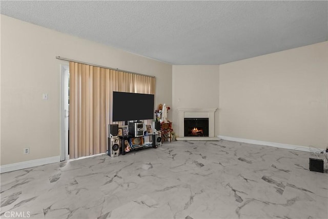 unfurnished living room with marble finish floor, visible vents, a textured ceiling, a warm lit fireplace, and baseboards