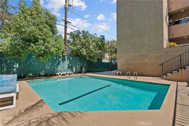 view of swimming pool with a fenced in pool, a patio area, and fence