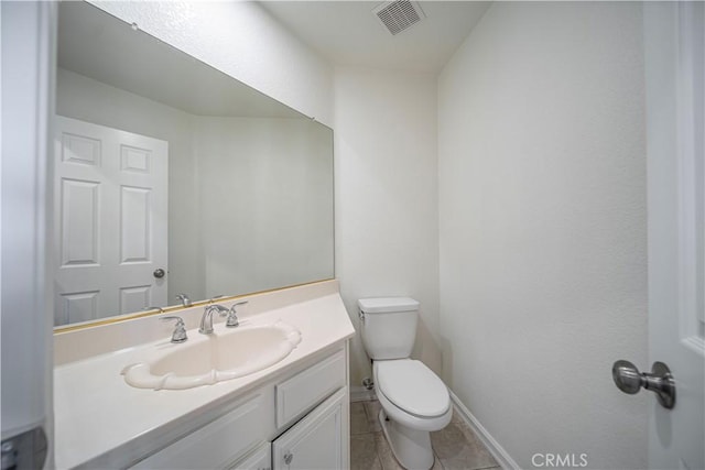 bathroom with baseboards, visible vents, toilet, tile patterned flooring, and vanity