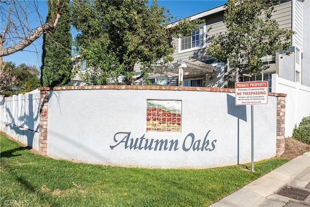 community / neighborhood sign with fence