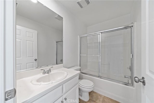 full bath featuring visible vents, toilet, shower / bath combination with glass door, tile patterned flooring, and vanity