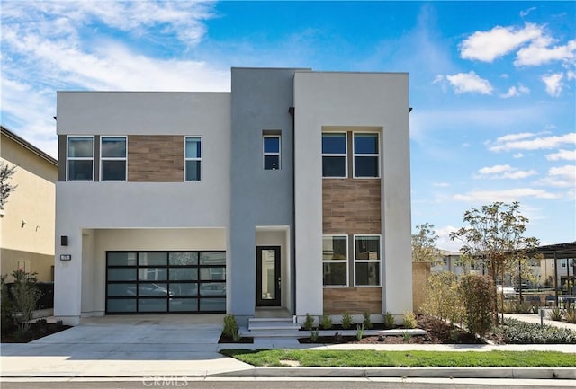 contemporary house featuring stone siding, stucco siding, driveway, and a garage