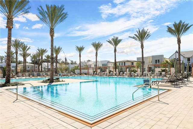 community pool featuring a patio area and a residential view