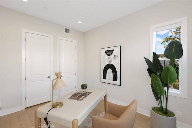 office featuring light wood-type flooring, visible vents, baseboards, and recessed lighting