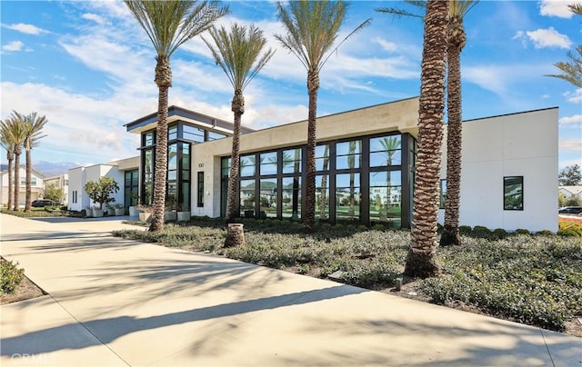 view of building exterior with concrete driveway