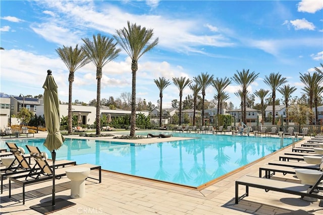 community pool featuring a patio and fence