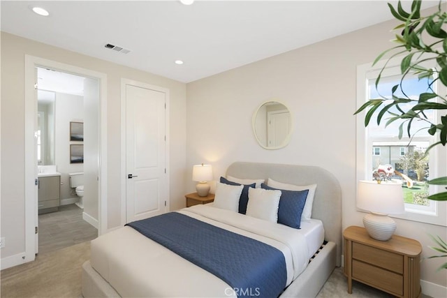 bedroom featuring recessed lighting, visible vents, ensuite bathroom, and baseboards