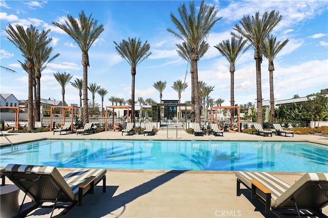 pool featuring a patio area and fence