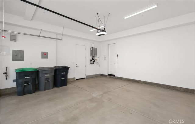 garage featuring electric panel, a garage door opener, baseboards, and water heater