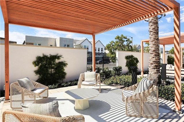 view of patio with an outdoor living space, fence, and a pergola