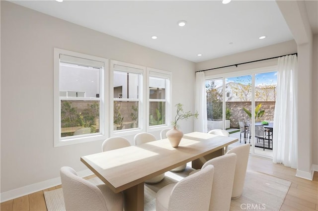 dining room featuring recessed lighting, light wood-type flooring, and baseboards