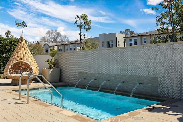 view of pool featuring a swimming pool, a patio, and fence