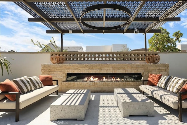 view of patio / terrace featuring an outdoor living space with a fireplace and a pergola