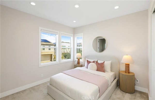 bedroom featuring light carpet, recessed lighting, and baseboards