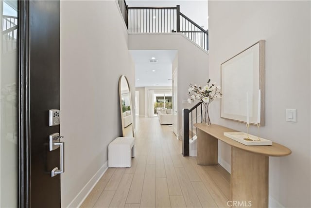 170 Wild Flower, Lake Forest, CA 92630 - entryway with light wood-type flooring, a towering ceiling, baseboards, and visible vents