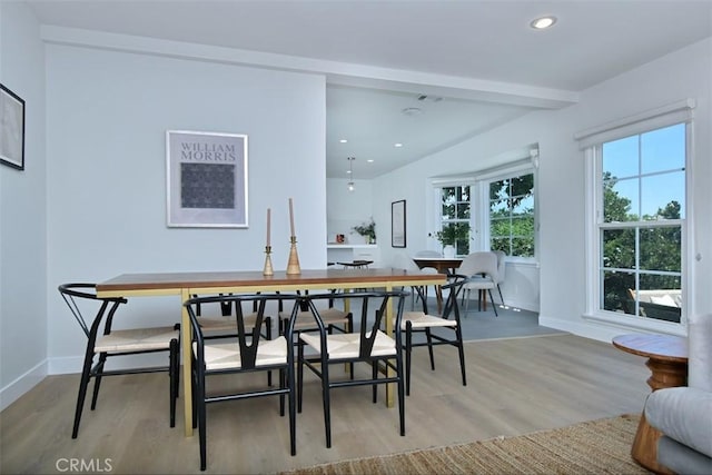 dining space with baseboards, light wood finished floors, beamed ceiling, and recessed lighting