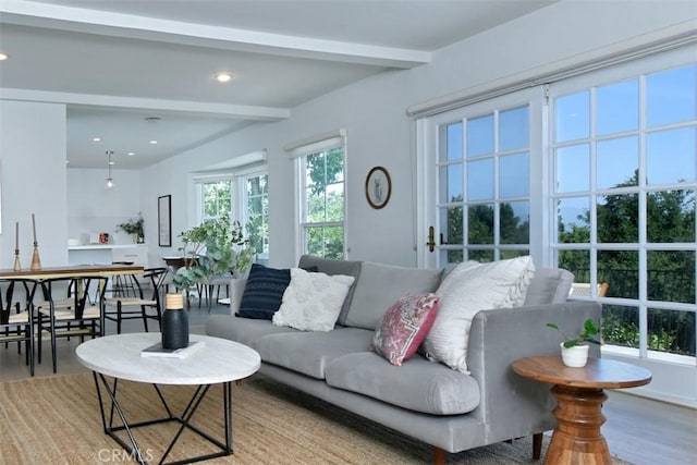 living area with beam ceiling and recessed lighting