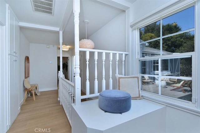 interior space featuring wood finished floors, visible vents, and baseboards