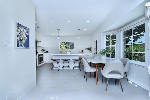 dining room with baseboards and recessed lighting