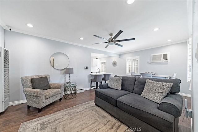 living room featuring a wall unit AC, crown molding, baseboards, and wood finished floors