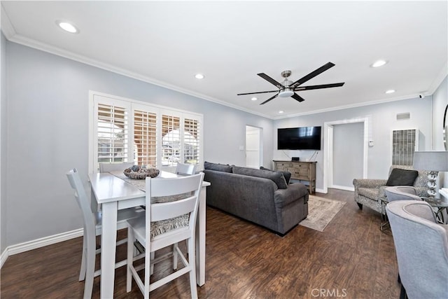 dining room featuring ornamental molding, recessed lighting, baseboards, and wood finished floors