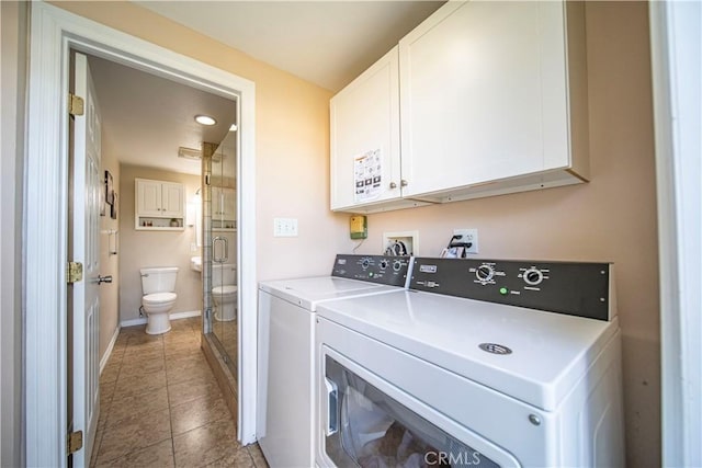 washroom with washer and clothes dryer, tile patterned flooring, cabinet space, and baseboards