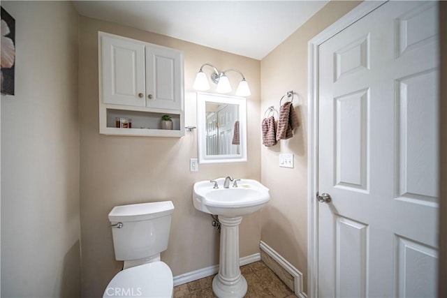 bathroom featuring baseboards, toilet, and tile patterned floors