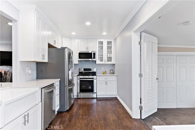 kitchen featuring glass insert cabinets, appliances with stainless steel finishes, and white cabinets