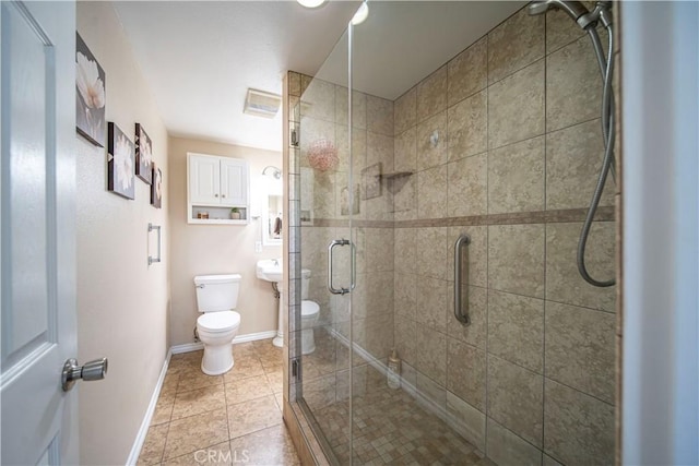 full bathroom featuring toilet, a stall shower, baseboards, and tile patterned floors