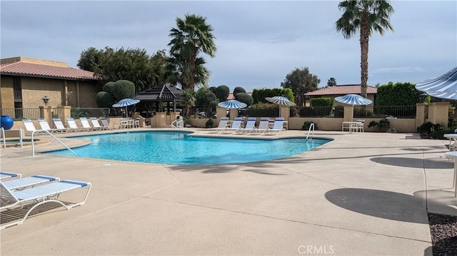 pool featuring a patio area and fence