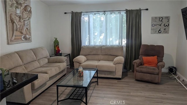 living area with light wood finished floors and baseboards