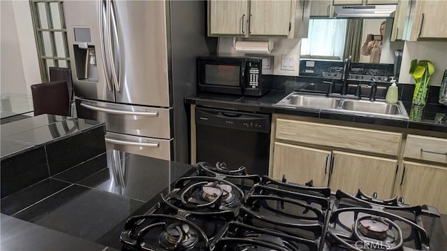 kitchen featuring tile countertops, black appliances, a sink, and light brown cabinetry