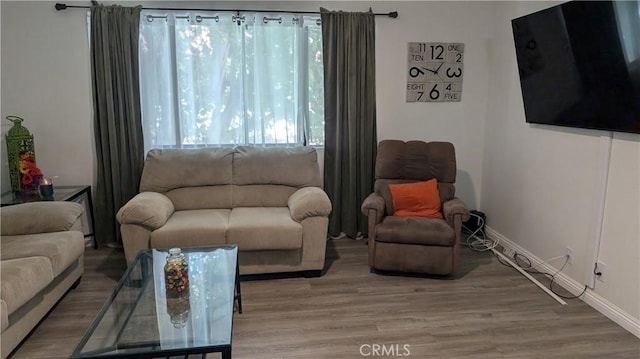 living room featuring light wood finished floors and baseboards