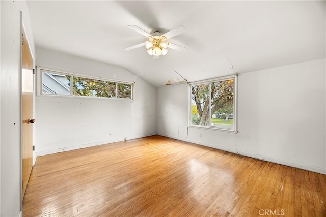 spare room with vaulted ceiling, ceiling fan, and wood finished floors