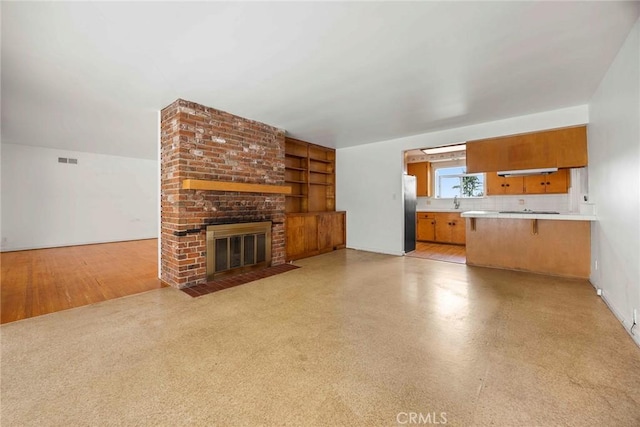 unfurnished living room with a brick fireplace