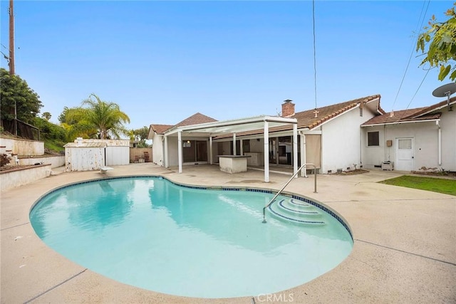 view of swimming pool featuring a diving board, a patio area, and a fenced in pool