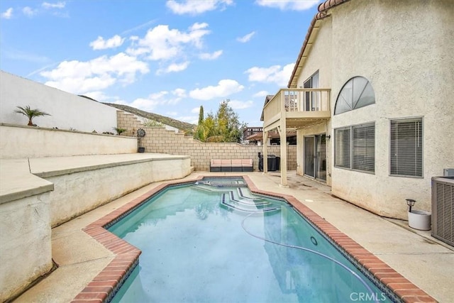 view of pool featuring a pool with connected hot tub, a fenced backyard, a patio, and central AC