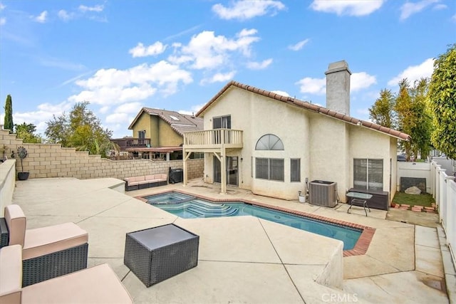 view of swimming pool with a fenced in pool, a patio area, an in ground hot tub, cooling unit, and a fenced backyard