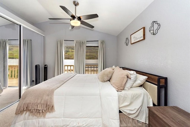 carpeted bedroom featuring lofted ceiling, a closet, a ceiling fan, and access to exterior