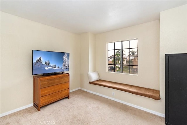 living room featuring carpet and baseboards